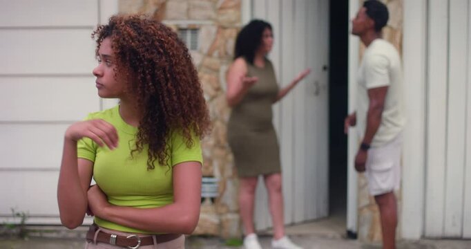Teenage girl standing in distress with troubled expression, parents arguing in background, family conflict, emotional tension, generational struggle, feeling overwhelmed