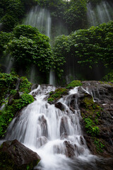 Lush Tropical Waterfall Flowing Through Green Jungle Landscape in Indonesia
