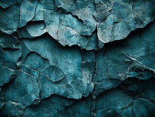 Teal Rock Texture: Abstract close-up shot of a teal colored rock surface, showcasing its rough, cracked, and layered texture.  The image is rich in detail and evokes a sense of depth and age. 