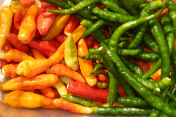 a bunch of green chilies and red chilies