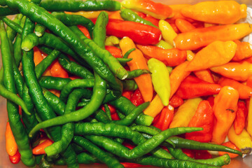a bunch of green chilies and red chilies
