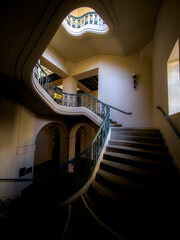 Obraz premium spiral staircase with various levels of light in vintage setting