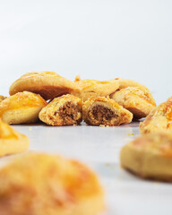 Indonesian nastar snack with pineapple jam filling. Freshly baked pastries filled with a rich, sweet filling are displayed, highlighting their soft texture and appealing presentation