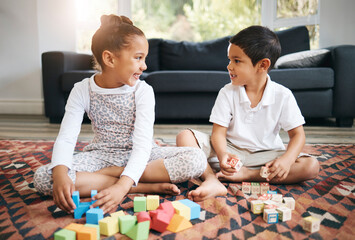 Children, siblings and building blocks for learning in home, cognitive development and education. Kids, brother and sister bonding together on living room floor, creative puzzle and shape games