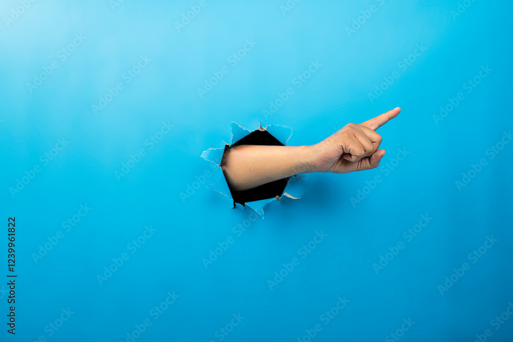 Poster human hand showing from ripped paper. hand gestures of pointing or counting. mockup or copy space. c