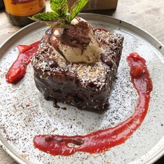 A beautifully presented meal and a refreshing beverage served at a modern restaurant, showcasing the rich flavors and vibrant dining culture