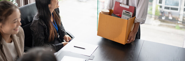 Business man sending resignation letter to boss and Holding Stuff Resign Depress or carrying cardboard box by desk in office.