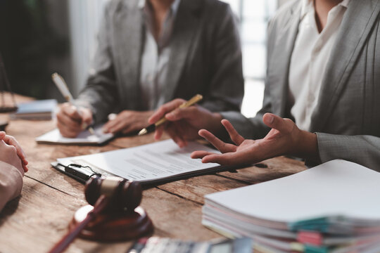 Lawyers discussing contract details during meeting in law firm