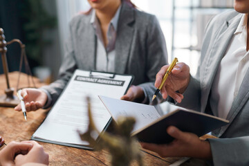 Lawyers reviewing contract agreement with client in office