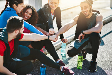 Fist bump, fitness and group of athletes outdoor with running for workout, health or wellness....
