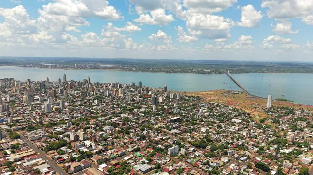 Panoramic aerial view of the city of Posadas, Argentina, with the large Paran&aacute; River and the city of Encarnaci&oacute;n, Paraguay, in the background.