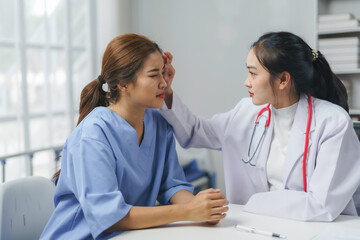Doctor checking patient fever in hospital room or clinic