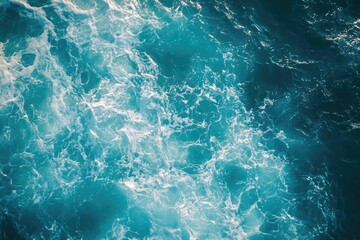 Fototapeta premium rippling turquoise ocean waves with sunlight dancing on surface aerial view