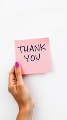Hand holding pink sticky note with thank you message displayed against white background