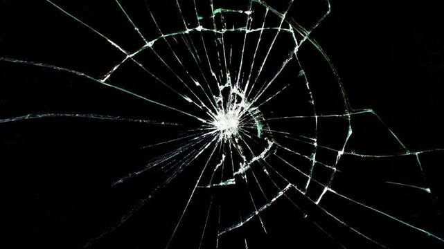 Cracked glass fracture effect on black background, Animation bullet through glass on background.
Abstract broken transparent glass texture. Cracked and Shattered black glass with slow motion. Alpha