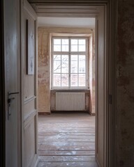 Fototapeta premium Open doorway reveals a bright room with textured walls and a window view of a bare tree