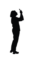 The silhouette of a woman standing using her phone emphasizes the connection women have with technology