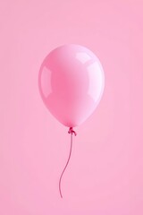 there is a pink balloon with a red string attached to it