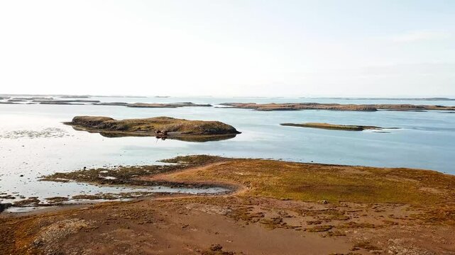 Aerial view capturing Bootswrack, a beacon of natural beauty in Breidhabolsstadhur, Iceland, with its breathtaking landscapes, volcanic formations, and stunning views with abandoned boats