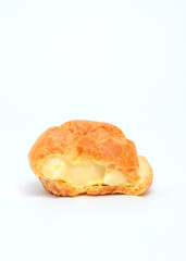Close up of cream puffs isolated on white background.Food industry concept.Copy space.Crispy skin cream puffs filled with cream from a mixture of butter and wheat flour.For graphic design or banner ba