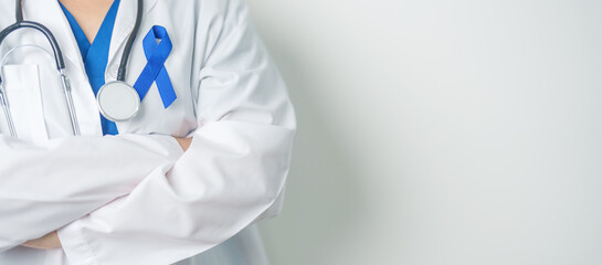 March Colorectal Cancer Awareness month, doctor with dark Blue Ribbon for supporting people living...
