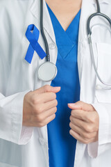 March Colorectal Cancer Awareness month, doctor with dark Blue Ribbon for supporting people living...
