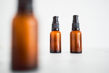 eye serum moisturizers with apothecary amber style bottle on minimalstic white marble background