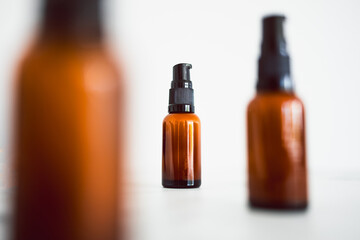 eye serum moisturizers with apothecary amber style bottle on minimalstic white marble background