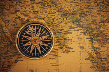 Compass on old map of the world. Journey and discovery concept