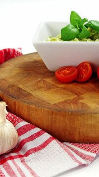 Cherry tomatoes and garlic with bowl of pasta