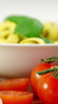 Cherry tomatoes and with bowl of pasta
