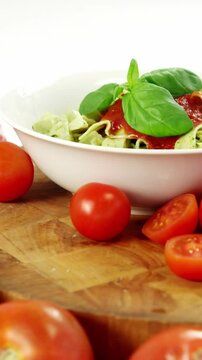 Cherry tomatoes and with bowl of pasta