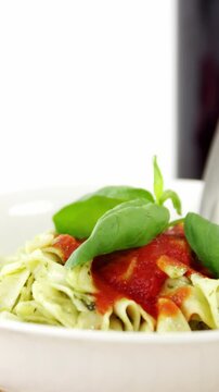 Glass of red wine with cooked pasta