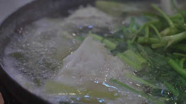 a soup made with water parsley and cod