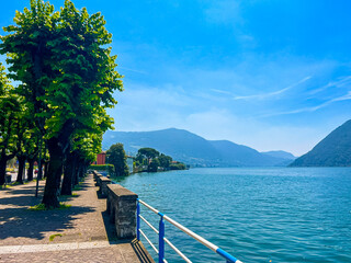 View of Iseo Lake Surrounded by Majestic Mountains and Clear Blue Skies, Italy