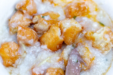 rice porridge or congee with minced pork and soft-boiled eggs