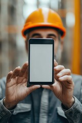 Naklejka premium Construction Worker Showing Blank Smartphone Screen