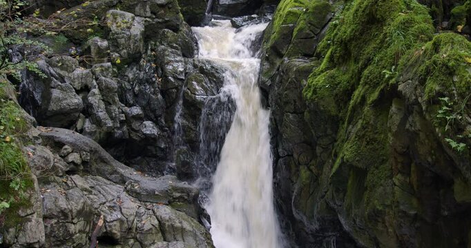 Mid shot of a waterfall on the river sychryd at Coed-Y-Rhaidyr, Pontneddfechan, Neath,