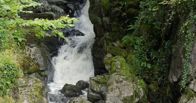 Wide shot of a waterfall on the river sychryd at Coed-Y-Rhaidyr, Pontneddfechan, Neath,
