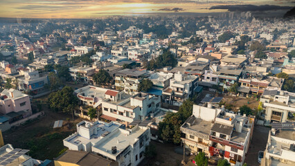 Aerial view of city with dramatic sky at evening time.