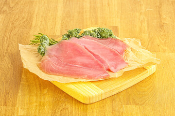 Raw salted tuna slice over board