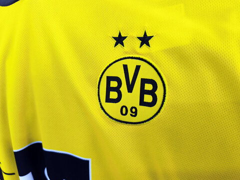 Close-up of dortmund bvb 09 logo on yellow football jersey fabric