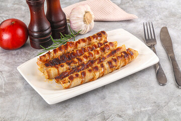 Grilled meat sausages wrapped bacon