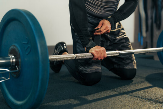 Strength training session with weights on the gym floor during a morning workout