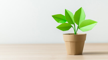 Fototapeta premium A desk features a pot containing an origami-style paper plant, exhibiting a minimalist design and a creative paper crafting style, suitable for design, decor, and sustainability-themed visuals.