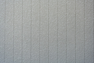 White concrete background wall with vertical line ribbed. Stripes as a texture.
