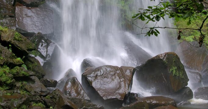 Mid shot of the base of the Melin Court waterfall with rocks. at Melin Court nature reserve