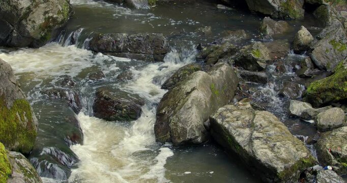The river sychryd cascading over rocks at Coed-Y-Rhaidyr, Pontneddfechan, Neath,