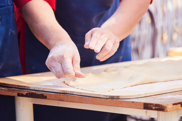 The cook's hands when working with the dough.