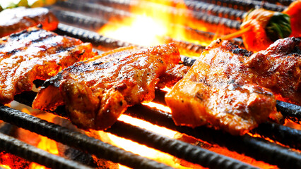 BBQ Barbecue grilled meat stick on fire flame with hot charcoal cooking outside. Beef grilling...